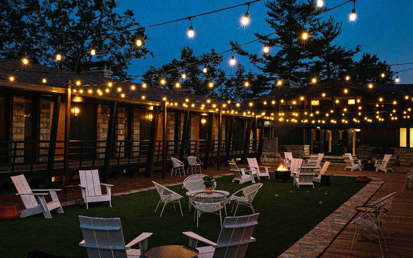 outdoor seating area for events at night time with outdoor furniture and lights